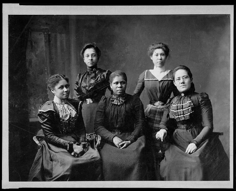 Black and white photo of group of five African American women, 3 sitting and 2 standing, from 1900