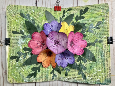 flowers made from paper pop out of a journal with a 3D effect