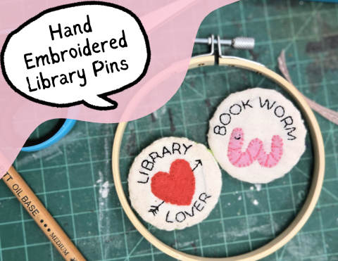 two small embroidered pins one says, "Library Lover" and the other says "Book Worm".