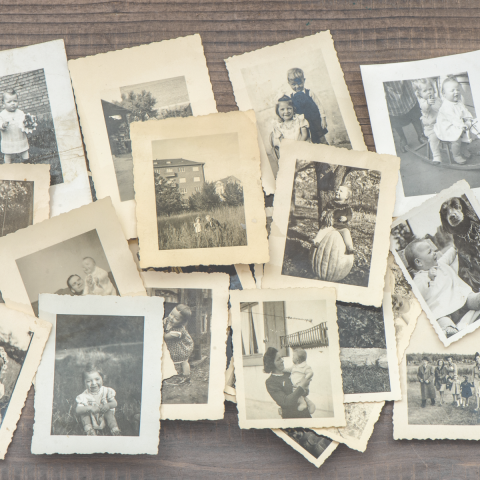 Scattered black and white 1940s photographs of various people of different ages