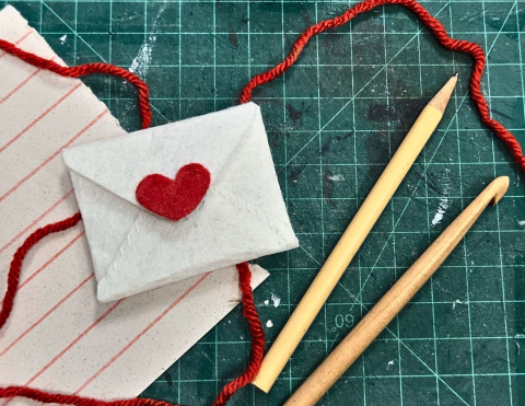 A felt envelope with a red heart on the front 
