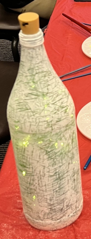 Wine bottle covered in paint and modpodge