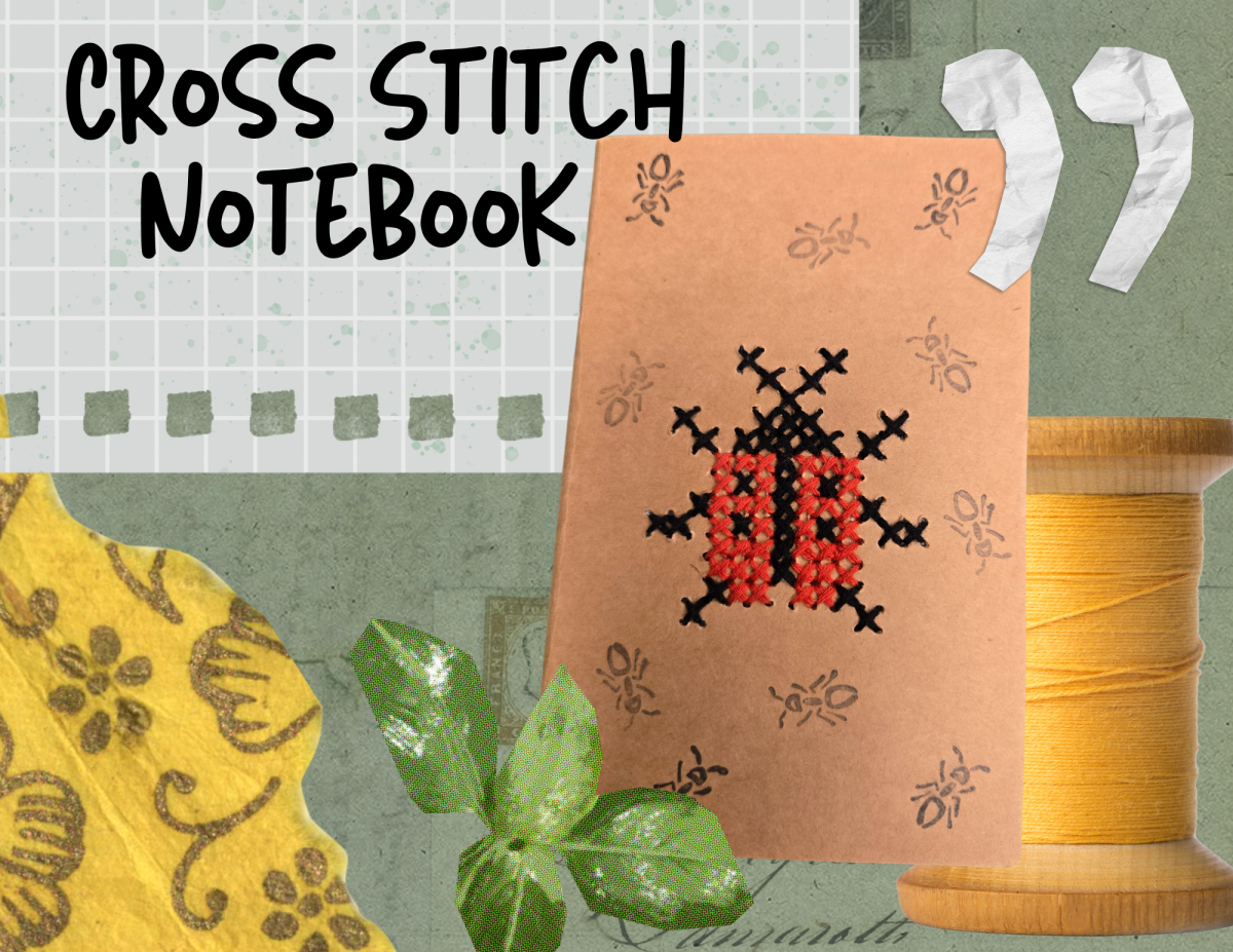a brown paper notebook with a cross-stitch ladybug motif 